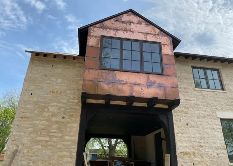 Copper metal panel facade on a stone building for Roof Repair in Tanque Verde