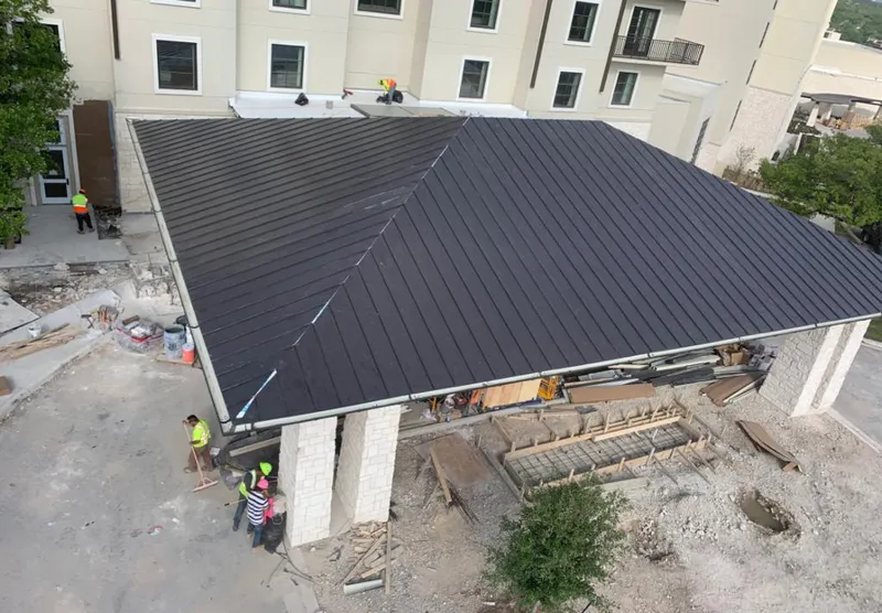 Metal roofing installation team working on a commercial building in Tanque Verde